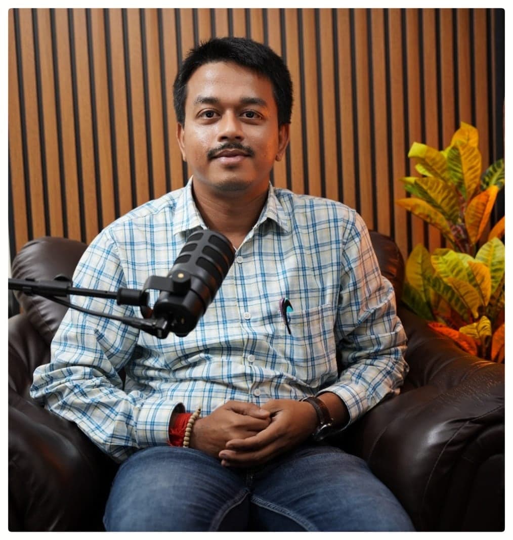 Dr. Sayan Banerjee recording a podcast episode.